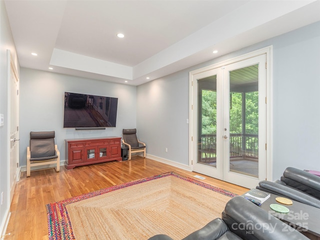 living room featuring wood finished floors, french doors, baseboards, and recessed lighting