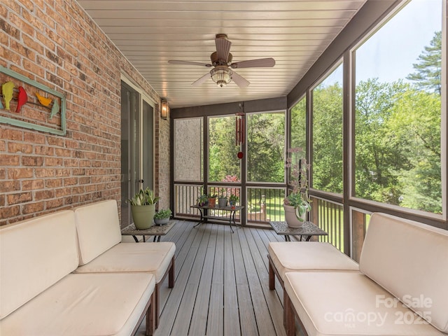sunroom featuring a ceiling fan, outdoor lounge area, and plenty of natural light