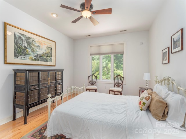 bedroom with a ceiling fan, recessed lighting, baseboards, visible vents, and wood finished floors
