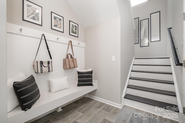 mudroom with baseboards, vaulted ceiling, and wood finished floors