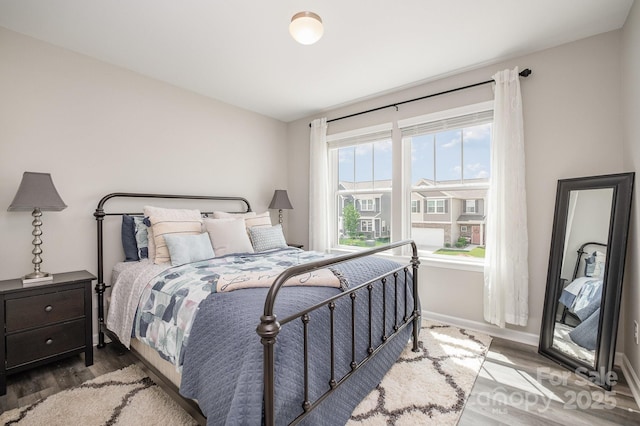bedroom featuring wood finished floors and baseboards