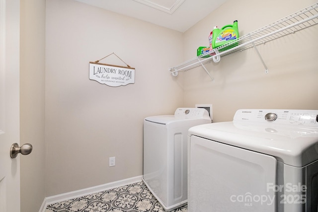 laundry area featuring washing machine and clothes dryer, baseboards, laundry area, and tile patterned flooring