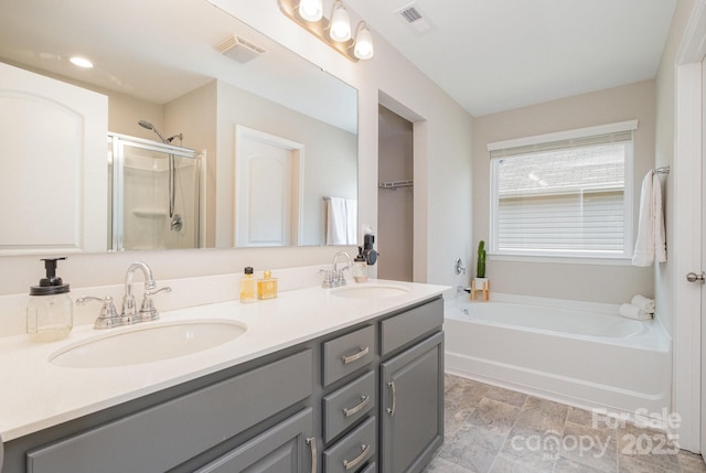 full bath featuring double vanity, visible vents, a shower stall, and a sink