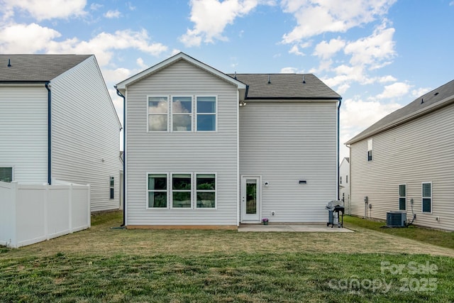 rear view of property with cooling unit, a patio area, fence, and a yard