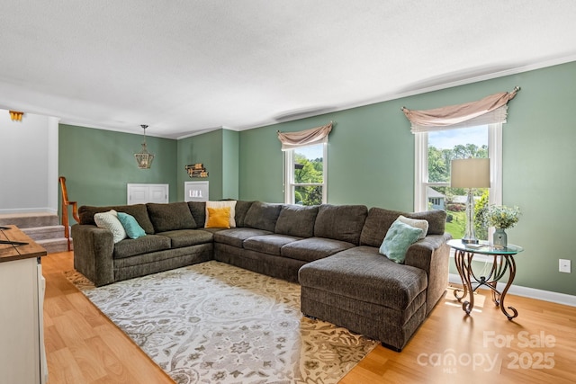 living area with light wood-style flooring and baseboards