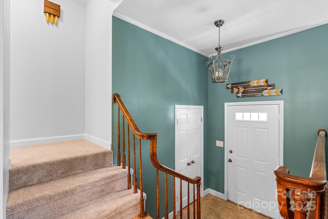 foyer featuring baseboards, a notable chandelier, crown molding, and stairway