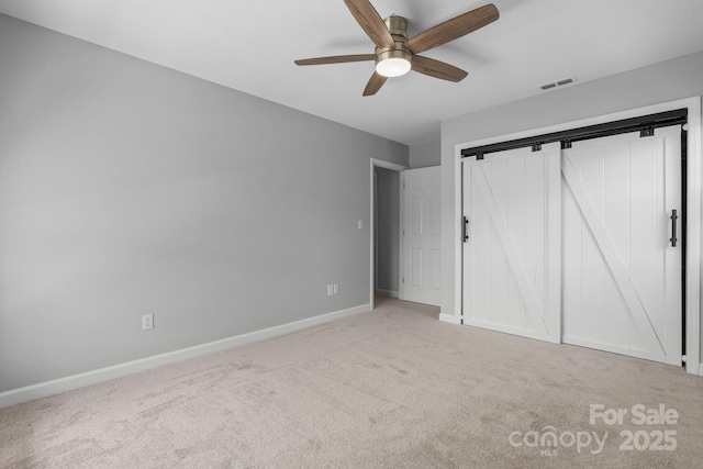 unfurnished bedroom with baseboards, carpet flooring, a closet, and visible vents