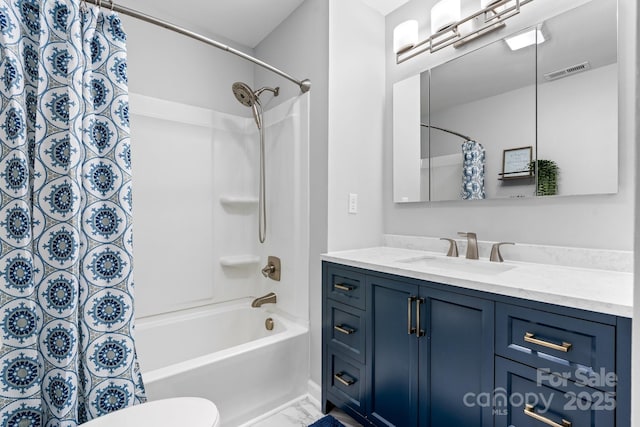 bathroom featuring toilet, visible vents, shower / bathtub combination with curtain, marble finish floor, and vanity