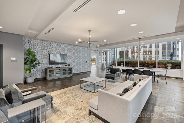 living room featuring a chandelier, wallpapered walls, wood finished floors, baseboards, and recessed lighting