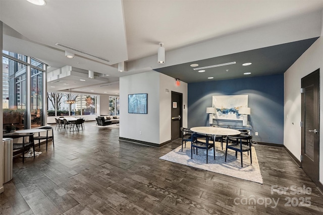 dining area with wood finished floors, baseboards, and recessed lighting