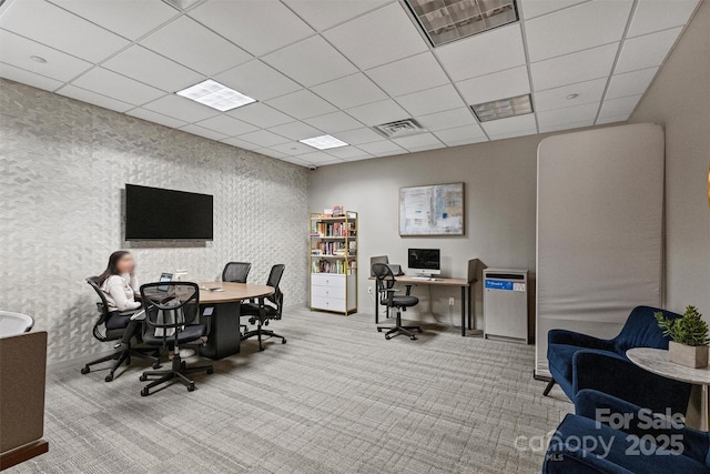 carpeted office space featuring a paneled ceiling, baseboards, and wallpapered walls
