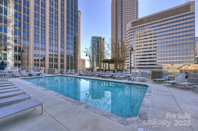 community pool featuring a patio and a city view