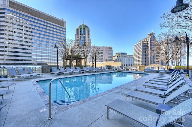 community pool featuring a view of city and a patio
