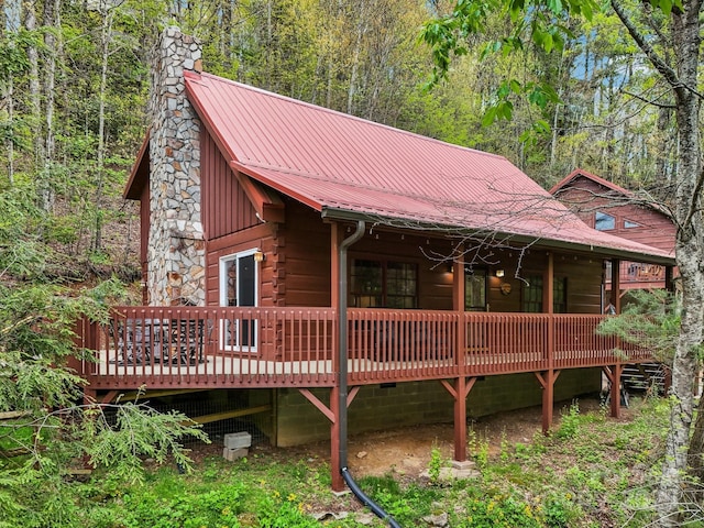 909 Niley Cook Rd, Blowing Rock, NC 28605 - exterior space with a chimney, metal roof, a view of trees, and a deck