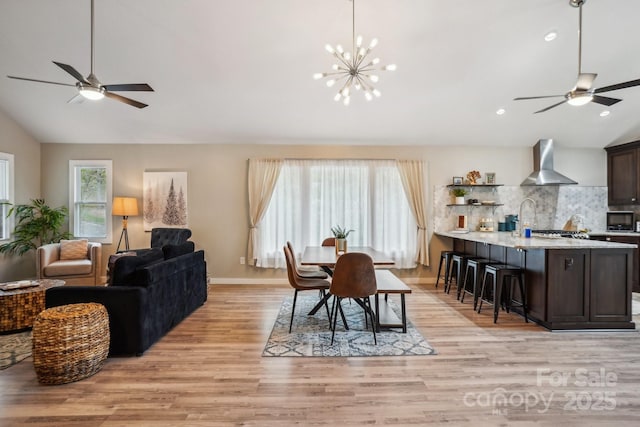 909 Niley Cook Rd, Blowing Rock, NC 28605 - dining area featuring lofted ceiling, ceiling fan with notable chandelier, light wood-type flooring, and recessed lighting