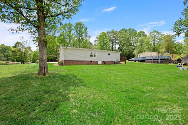 back of property with a yard and crawl space