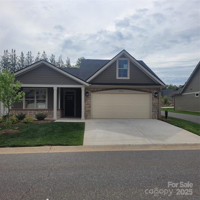 835A Wynnshire Dr Unit 53, Hickory, NC 28601 - craftsman-style house featuring concrete driveway, stone siding, covered porch, and a front yard