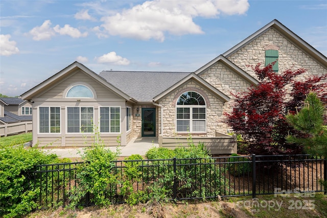 33 Braeburn Way, Flat Rock, NC 28731 - view of front of home with stone siding and a fenced backyard