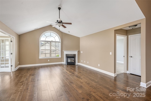 33 Braeburn Way, Flat Rock, NC 28731 - unfurnished living room with a premium fireplace, baseboards, dark wood finished floors, ceiling fan, and vaulted ceiling