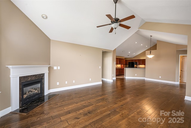 33 Braeburn Way, Flat Rock, NC 28731 - unfurnished living room featuring a premium fireplace, dark wood finished floors, baseboards, and ceiling fan