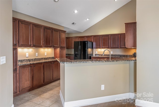 33 Braeburn Way, Flat Rock, NC 28731 - kitchen featuring a peninsula, dark stone counters, visible vents, recessed lighting, and black refrigerator with ice dispenser