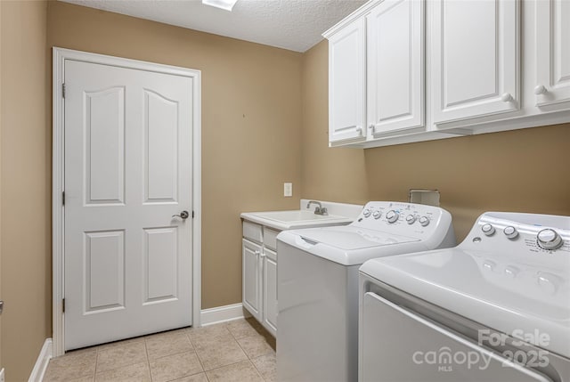 33 Braeburn Way, Flat Rock, NC 28731 - laundry area featuring washer and dryer, light tile patterned floors, a sink, cabinet space, and baseboards