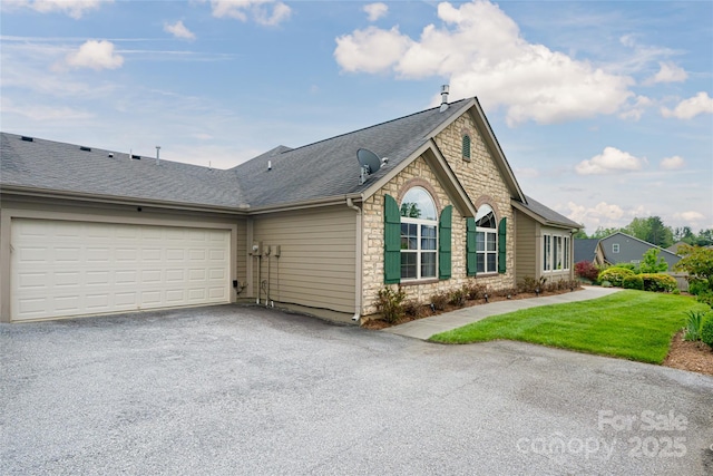 33 Braeburn Way, Flat Rock, NC 28731 - single story home featuring driveway, a front yard, an attached garage, stone siding, and roof with shingles