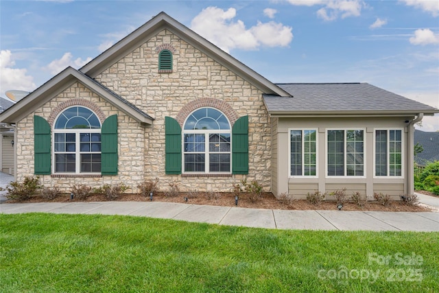 33 Braeburn Way, Flat Rock, NC 28731 - view of front of property with stone siding, a shingled roof, and a front lawn