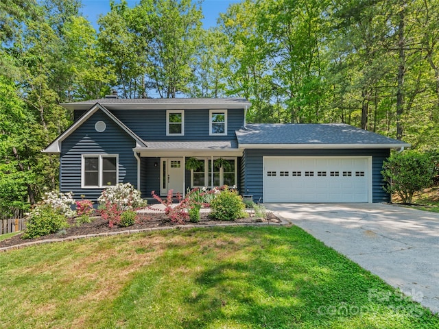 traditional-style home with a garage, driveway, covered porch, and a front yard