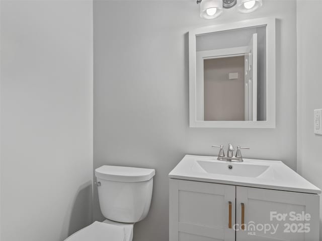 bathroom featuring toilet and vanity