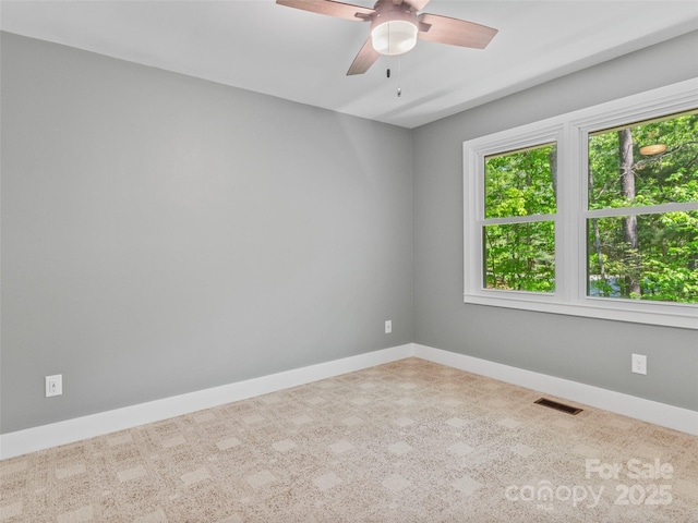 unfurnished room featuring baseboards and ceiling fan
