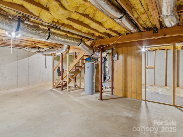unfinished below grade area featuring water heater and stairs