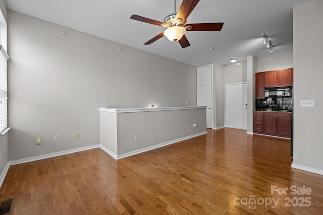 2125 Southend Dr Unit 448, Charlotte, NC 28203 - unfurnished living room featuring ceiling fan, wood finished floors, and baseboards