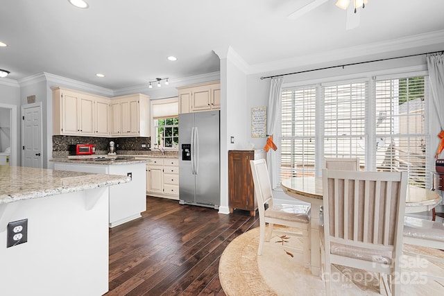 16028 Hallaton Dr, Huntersville, NC 28078 - kitchen featuring stainless steel appliances, tasteful backsplash, cream cabinets, ornamental molding, and dark wood-type flooring