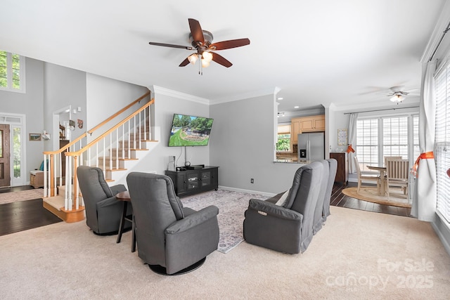 16028 Hallaton Dr, Huntersville, NC 28078 - living room featuring stairway, ceiling fan, crown molding, and light colored carpet