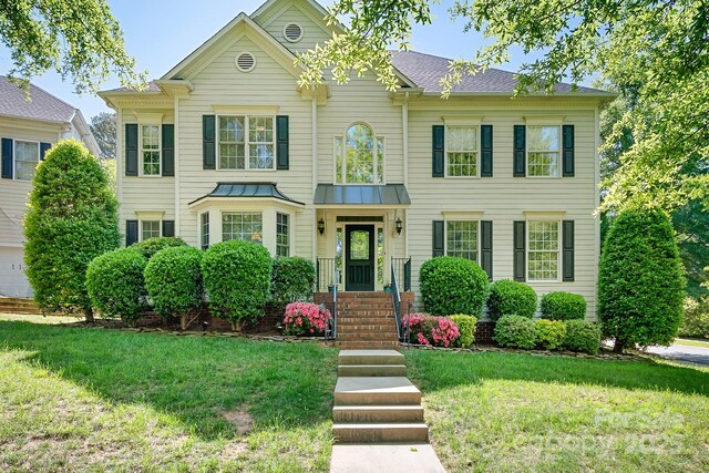 16028 Hallaton Dr, Huntersville, NC 28078 - view of front of home featuring a front lawn and a standing seam roof