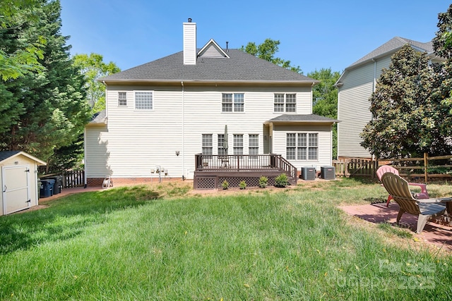 16028 Hallaton Dr, Huntersville, NC 28078 - rear view of property featuring a deck, a shed, a fenced backyard, and a chimney