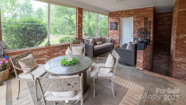 sunroom featuring an outdoor hangout area, a ceiling fan, and a healthy amount of sunlight