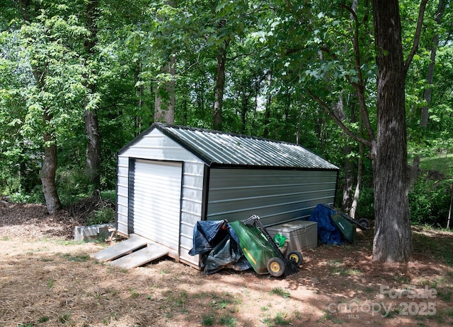 garage featuring a storage shed