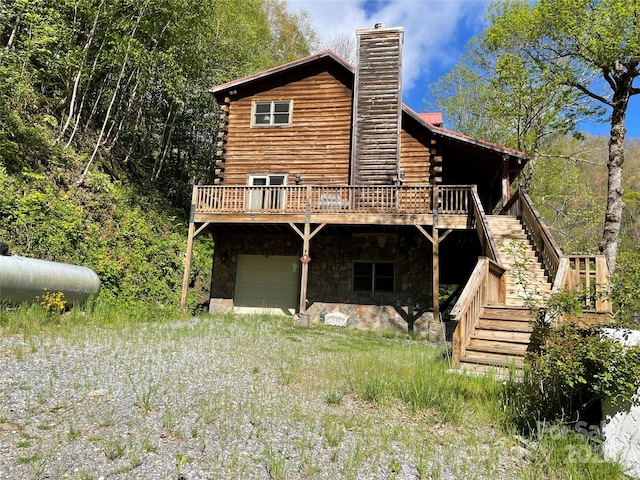 96 Trails End Ln, Maggie Valley, NC 28751 - back of house featuring an attached garage, a chimney, a deck, and stairs