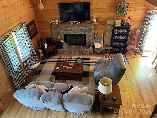 96 Trails End Ln, Maggie Valley, NC 28751 - living room featuring plenty of natural light, wooden walls, wood finished floors, and a stone fireplace