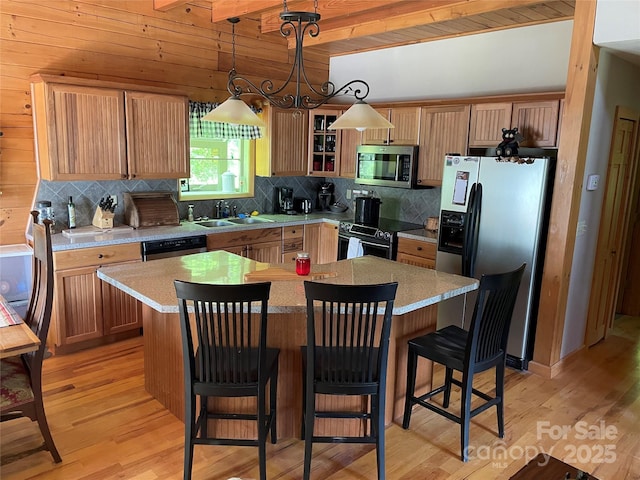 96 Trails End Ln, Maggie Valley, NC 28751 - kitchen with appliances with stainless steel finishes, light wood-type flooring, decorative backsplash, a sink, and beam ceiling