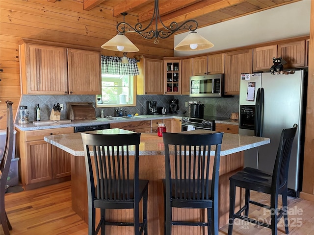 96 Trails End Ln, Maggie Valley, NC 28751 - kitchen featuring stainless steel microwave, refrigerator with ice dispenser, a sink, light wood-style flooring, and beam ceiling