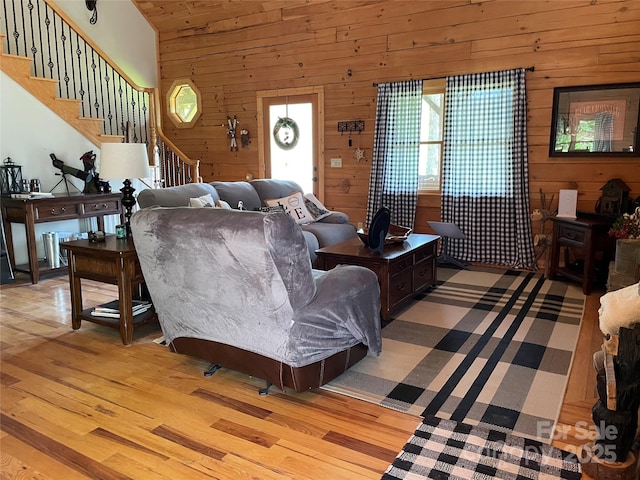 96 Trails End Ln, Maggie Valley, NC 28751 - living area featuring light wood-type flooring, wood walls, and stairs