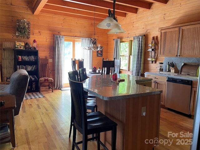 96 Trails End Ln, Maggie Valley, NC 28751 - kitchen featuring stainless steel dishwasher, beam ceiling, light wood-style floors, wooden walls, and a breakfast bar area