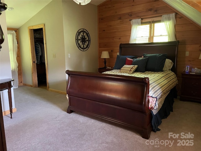 96 Trails End Ln, Maggie Valley, NC 28751 - bedroom with lofted ceiling, wood walls, carpet floors, and baseboards