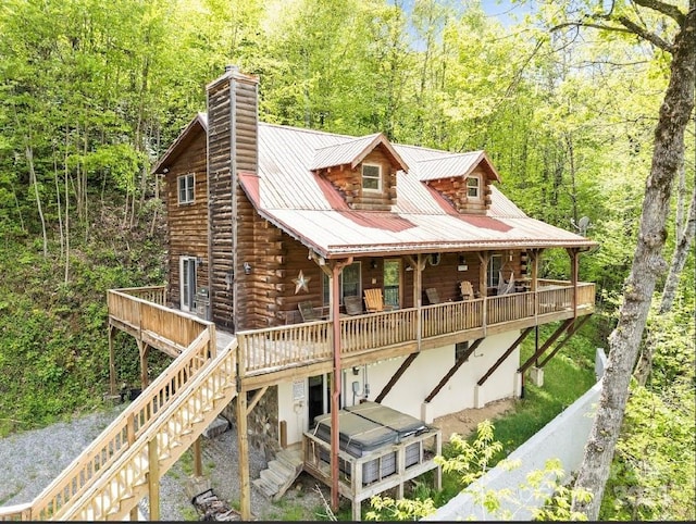 96 Trails End Ln, Maggie Valley, NC 28751 - back of property with log exterior, a hot tub, a chimney, stairs, and a deck