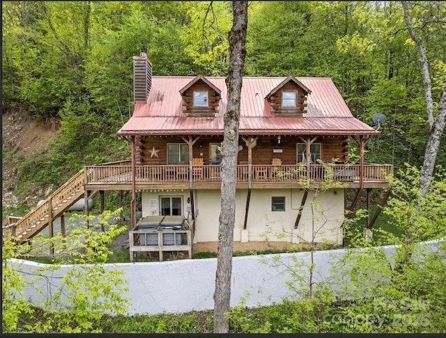 96 Trails End Ln, Maggie Valley, NC 28751 - back of property with log siding, a chimney, stairs, stucco siding, and a forest view