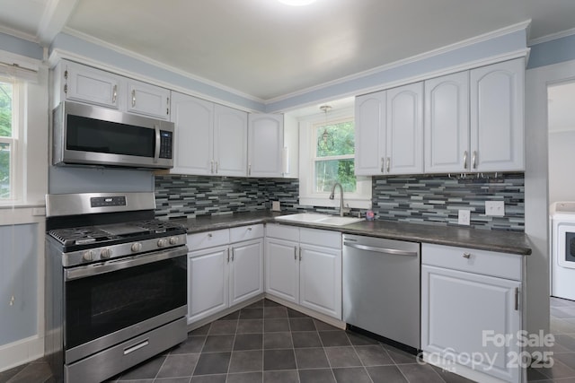 917 Laye St, Belmont, NC 28012 - kitchen featuring stainless steel appliances, a sink, dark countertops, tasteful backsplash, and crown molding