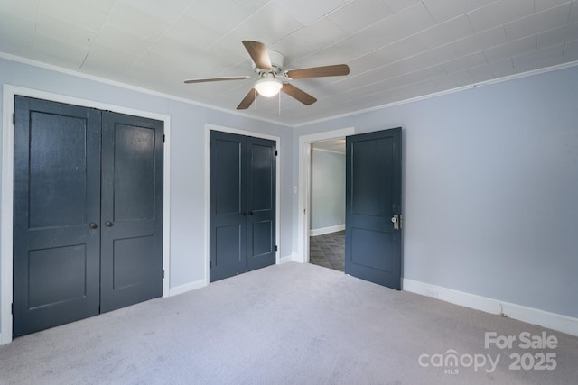 917 Laye St, Belmont, NC 28012 - unfurnished bedroom with carpet flooring, ornamental molding, baseboards, ceiling fan, and multiple closets